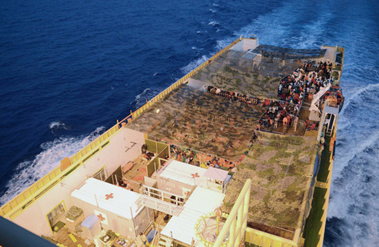 The holding area for migrants on the quarterdeck. To the fore (bottom left of the picture) is shown the treatment area for…